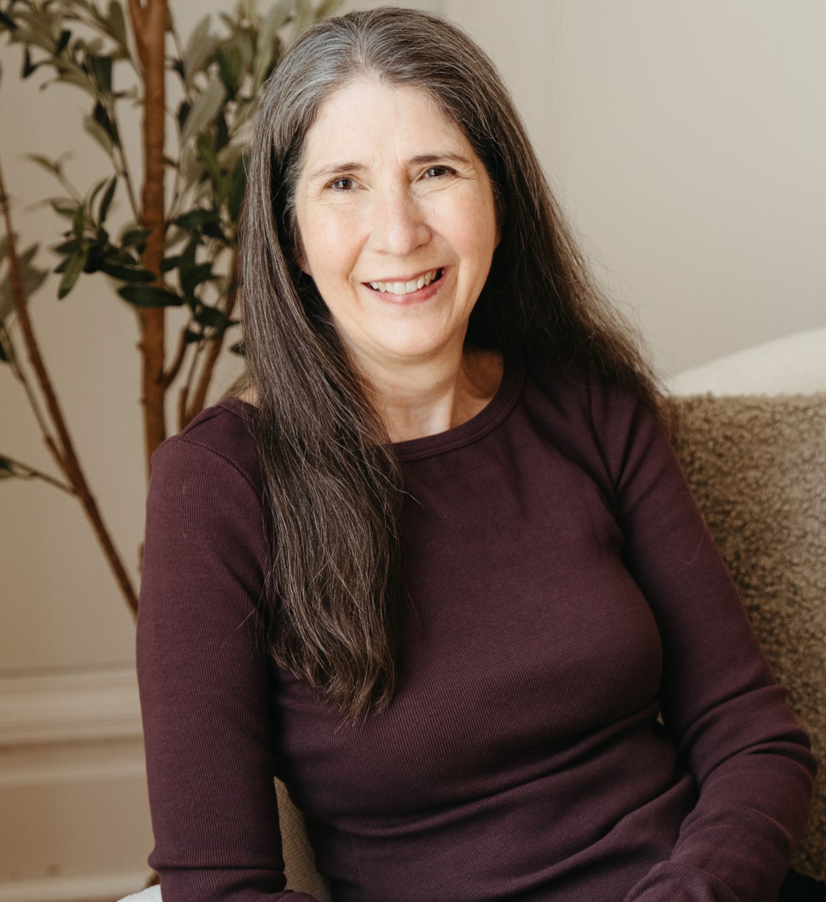 Mori Montagne - smiling brunette in purple shirt